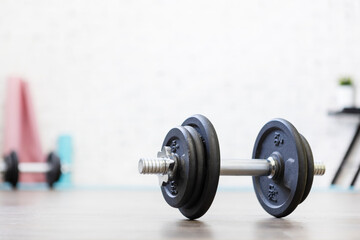 Close-up shot of a dumbbell on the floor that was just left during a workout