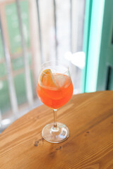 Aperol spritz on wooden table. Fresh and iced summer drink