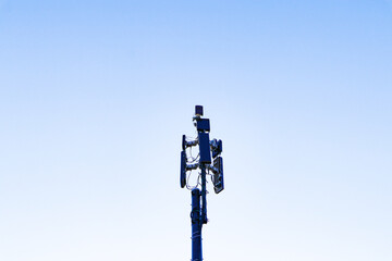 Obraz premium Communication tower telephone pole wireless technology signal future with electric wire tangle. Telecommunication tower of 4G and 5G cellular. Group box Antenna mounted. Sunlight cloud sky background 