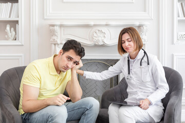 Sad male patient and female doctor discussing about health care problems