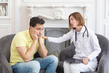 Sad male patient and female doctor discussing about health care problems