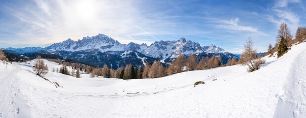 Fototapeta na wymiar Wide panoramic view of winter landscape with snow covered Dolomites in Kronplatz, Italy
