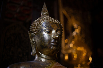 Fototapeta premium The head of a Buddha statue in an old temple in Chiang Mai, Thailand