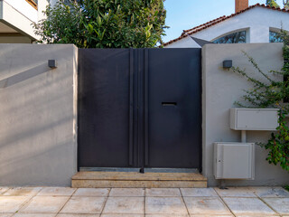 A contemporary design house entrance with a plain iron door at posh suburbs of Athens. Travel in...
