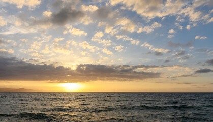 sunset over the Mediterranean sea in spring, clouds sun sea