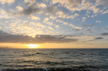 Fototapeta na wymiar sunset over the Mediterranean sea in spring, clouds and sea