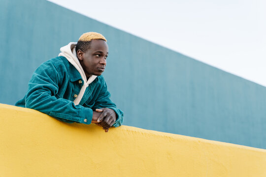 Young African American man with casual look . Trendy Generation Z young back man alone