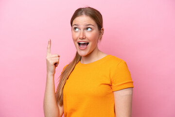 Young caucasian woman wearing band aid isolated on pink background intending to realizes the solution while lifting a finger up - obrazy, fototapety, plakaty