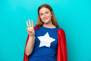 Super Hero caucasian woman isolated on blue background happy and counting three with fingers