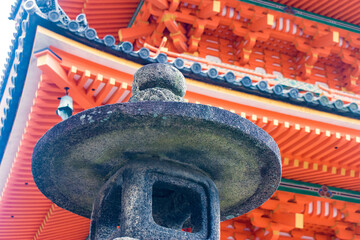 Ancient Charm and Vivid Colors: A Close-up of Kiyomizudera's Stone Lantern with Sanjunoto (Three...