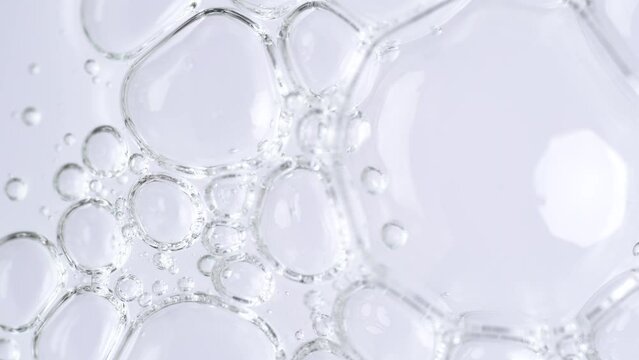 Motion of molecule bubbles in a cosmetic serum, macro. Transparent cosmetic gel fluid with molecule bubbles. Macro shot of natural organic cosmetics, health care , medicine. Slow Motion