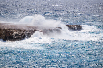 Big waves in the sea. Seascape during a storm with big waves crashing against the rocks