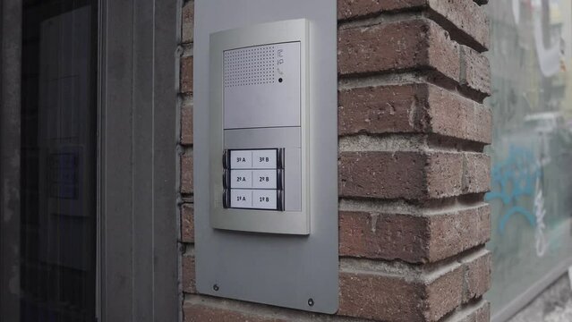 Close up of woman hand ringing the doorbell 