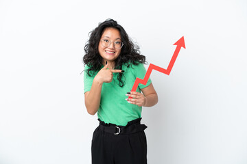 Young asian woman isolated on white background holding a catching a rising arrow with surprised...