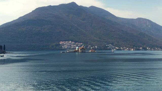 View of islands in the Bay of Kotor. The Island of Our Lady of the Rocks near the town of Perast. Adriatic Sea. Perast, Montenegro. Europe.