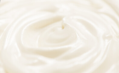 Sour cream or greek yogurt swirl texture, White cream background, close up. Dairy product. Delicious organic creamy yogurt. Milk cream. 