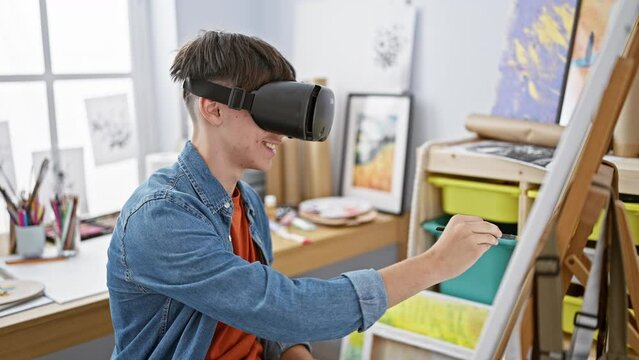 Young caucasian male artist using virtual reality headset in a creative studio setting.