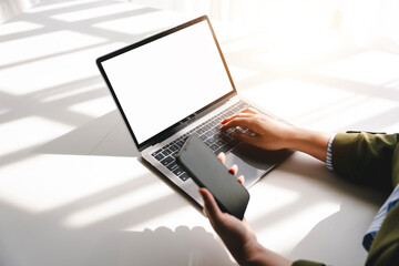 Typing on a smartphone Working online on laptop, computer and smartphone on white table at office. Facebook chat. Web meeting. Blogger. Journalist writing an article. online job idea