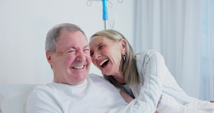 Senior, conversation and happy couple in hospital bed for visit, support and laugh together at funny story with sick husband. Smile, man. and woman talking in clinic for wellness, medical or health
