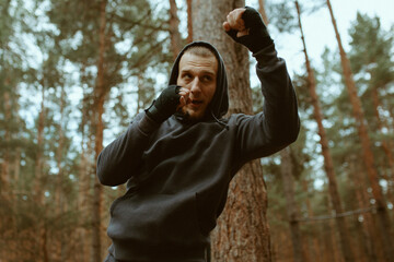 Boxer man traning in the forest. Shadow boxing. Boxer jog. Sport motivation. Outdoor training