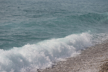 Pebble beach with nice clean sea waves - 778172089