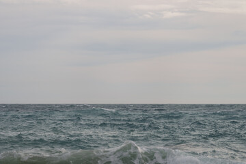 Fototapeta na wymiar Background of stormy mediterranean sea with horizon