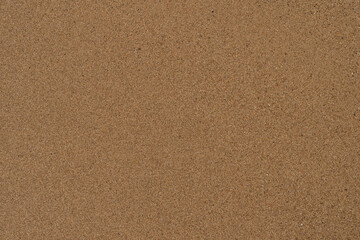 Fototapeta na wymiar Texture of wet sand on a beach top view