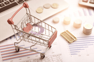 Coins, abacus, and carts placed on data reports