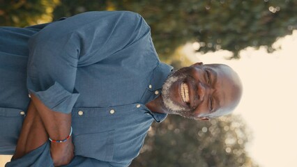 Vertical video close up of smiling senior man outdoors in countryside enjoying nature- shot in slow motion - Powered by Adobe