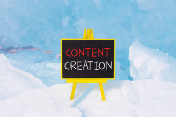 Time for content creation symbol. Concept words Content creation on beautiful yellow black blackboard. Beautiful blue ice background. Business time for content creation concept. Copy space.