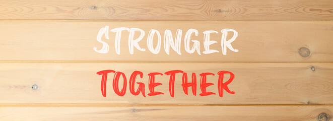 Stronger together symbol. Concept words Stronger together on beautiful wooden wall. Beautiful wooden wall background. Business, motivational and stronger together concept.