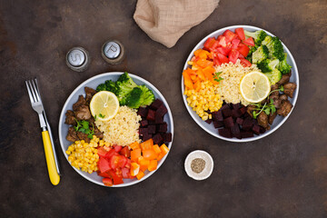 Bowl dish with fried turkey liver, bulgur, beet, pepper, tomato, broccoli, sweet corn, lemon. Healthy balanced eating. Top view
