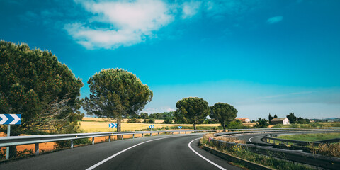Beautiful Turn Of Asphalt Freeway, Motorway, Highway Against The Background Of Southern Spanish Landscape. Travel Road Concept. Girona, Spain.