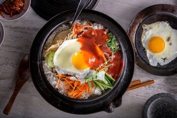 Sizzling Bi Bim Bap: 4K Ultra HD Top View, Mixed Vegetables, Rice, and Hot Sauce in Cast Iron Pot