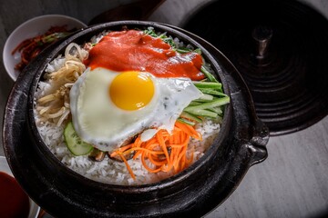 Sizzling Bi Bim Bap: 4K Ultra HD Top View, Mixed Vegetables, Rice, and Hot Sauce in Cast Iron Pot