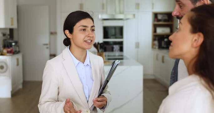 Indian woman, real-estate agent sold dwelling to couple, shake hands express respect, giving bunch of keys, congratulate with good purchase or short rent flat for vacation. Tenancy, selling property