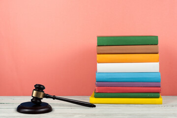 Law concept open book with wooden judges gavel on table in a courtroom or law enforcement office,...
