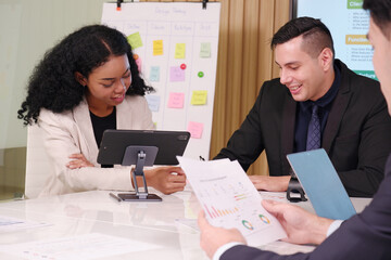 Businessmen and employees sit in a conference room for a marketing planning meeting.