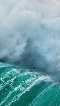 High quality vertical slow motion shot of sea or ocean surf with white foam. Huge wave crashing in open water of Atlantic ocean
