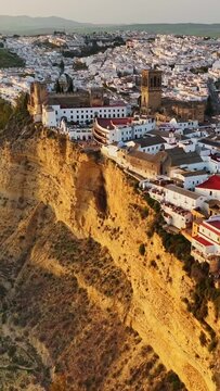 Arcos de la Frontera, Andalusia, Spain at sunset. Aerial shot one of famous pueblos blancos in Andalusia - Arcos de la Frontera. Vertical screen
