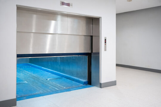 Modern freight elevator featuring a sleek two-section slide-up door design