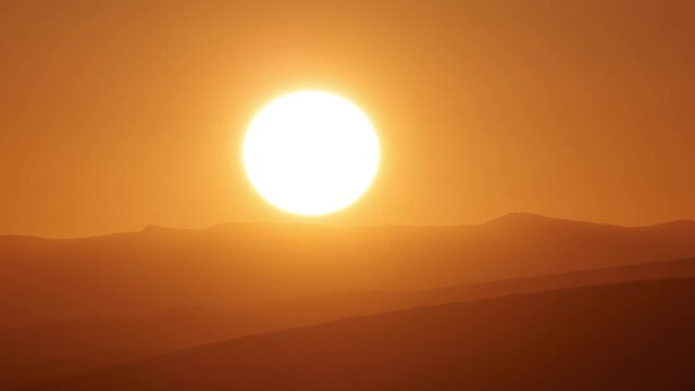 Big sun close-up rising at mountain. Beautiful nature video time lapse landscape.