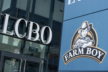 Fototapeta premium exterior buildings and signs for Farm Boy, a fresh food market and LCBO, a liquor store, located at 15 Cooper Street in downtown Toronto, Canada