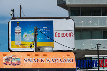 Fototapeta premium billboard with Gordon's and sign of Snack Savaari located near 7 Queens Quay East in Toronto, Canada