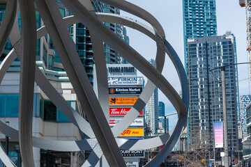 Fototapeta premium public sculpture and business sign located at 10 Yonge Street in downtown Toronto, Canada