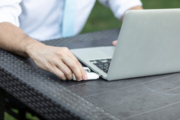 Close-up of businessman holding optional removable router to enhance the signal on a laptop for...