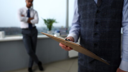 Male clerk arm in suit and tie with paper clipped to pad at office workplace closeup. Strike bargain for profit white collar motivation union decision corporate sale insurance agent purchase