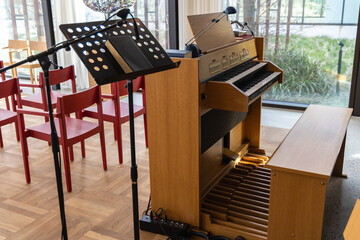 Small indoors pipe organ. Musical instrument for church singing.