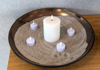 Electric, Led candles in sand in a large bowl.