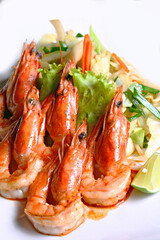 Grilled tiger shrimps with spice and lemon with fresh salad leaf in white background 